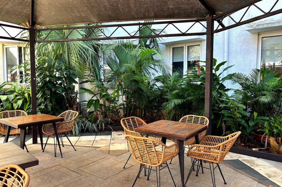 Outdoor restaurant area surrounded by greenery at Grand Baie Business Park